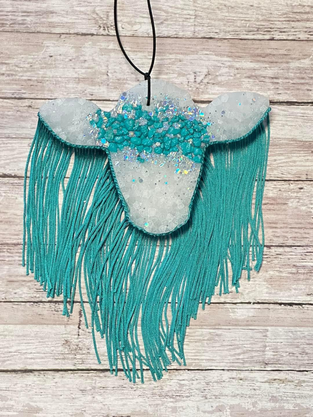 Cow with teal fringe